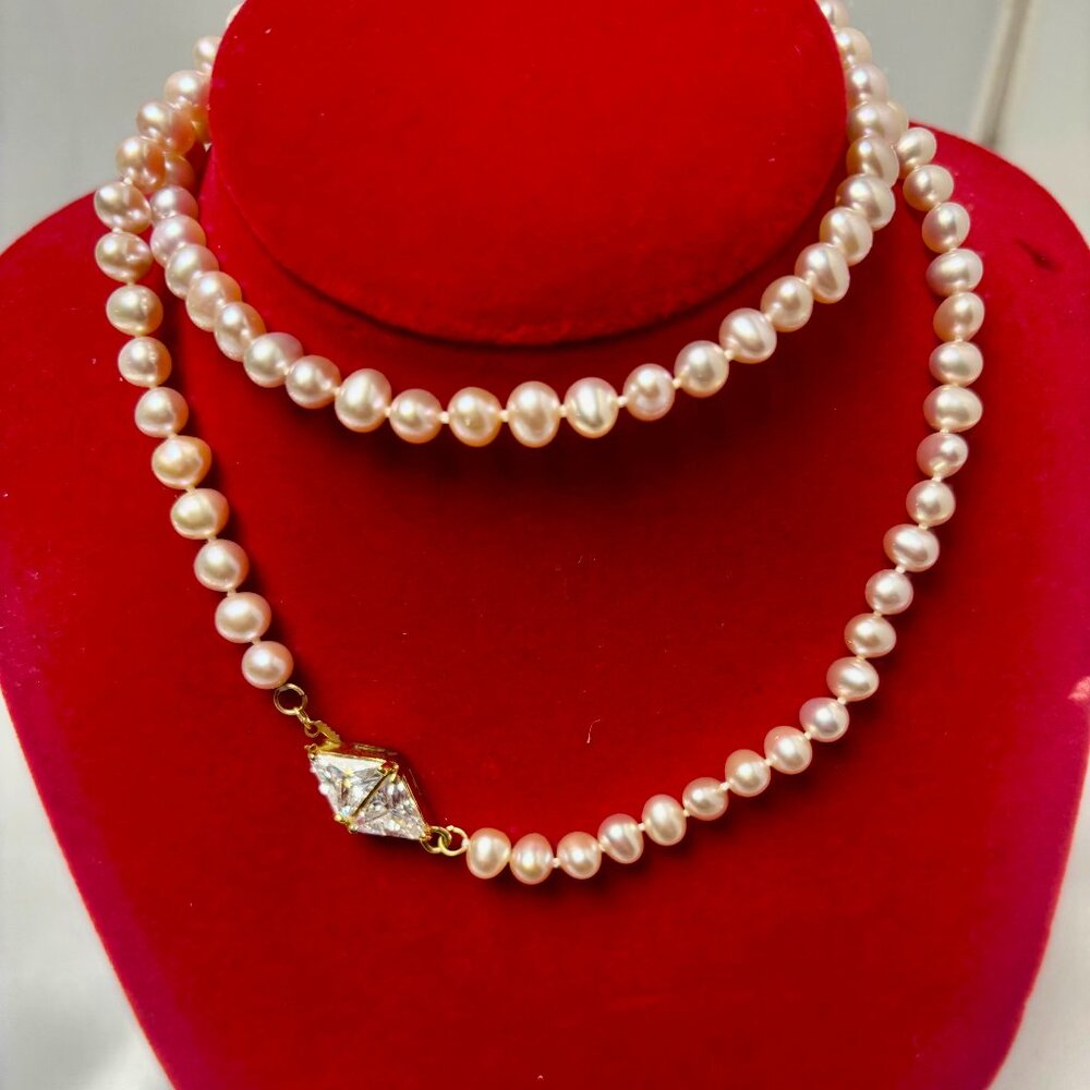 Pink strand of  fresh water pearl necklace with gold plated CZ clasp.
